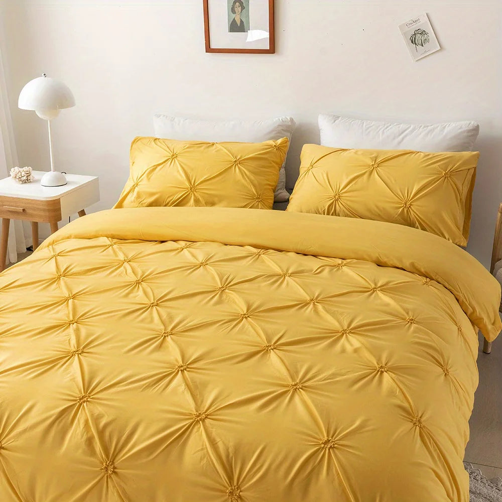A bright yellow quilted bedding set featuring a duvet, pillows, and a matching yellow throw on a bed.
