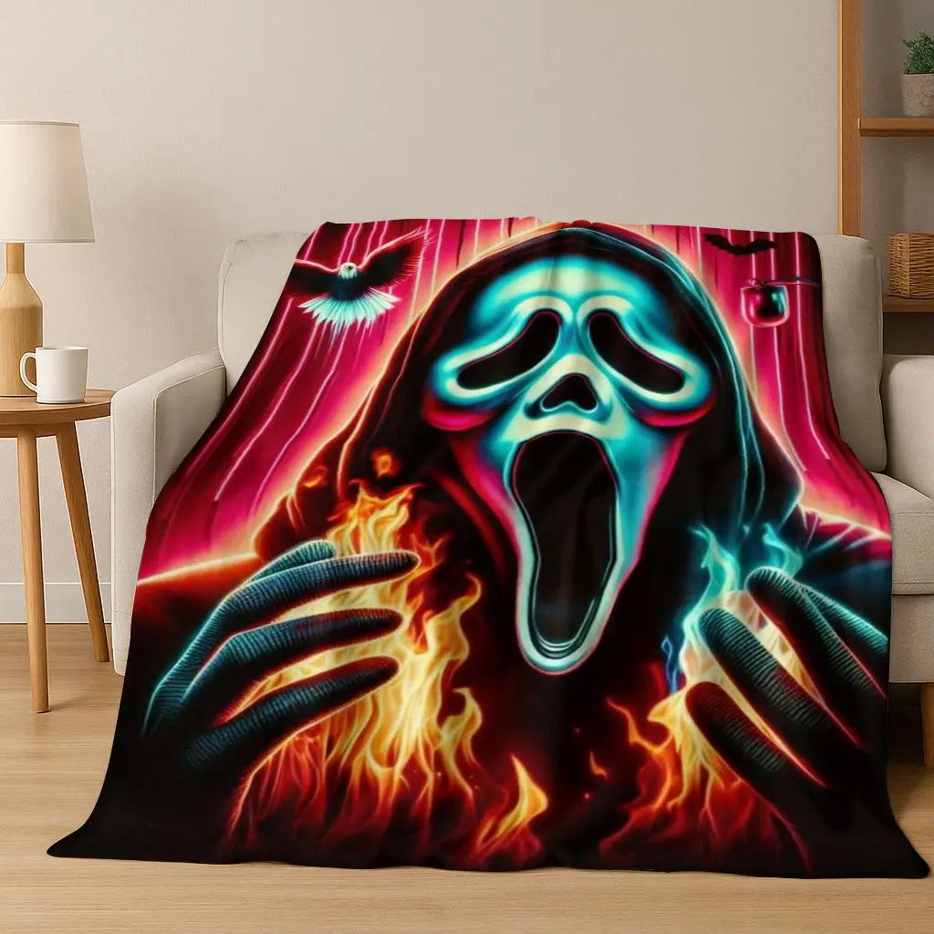 A dark flannel throw blanket featuring a glowing, screaming horror character face with bright neon pink and blue accents.