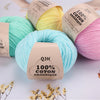 A collection of natural colored organic cotton yarn spools and skeins for knitting and crochet projects.