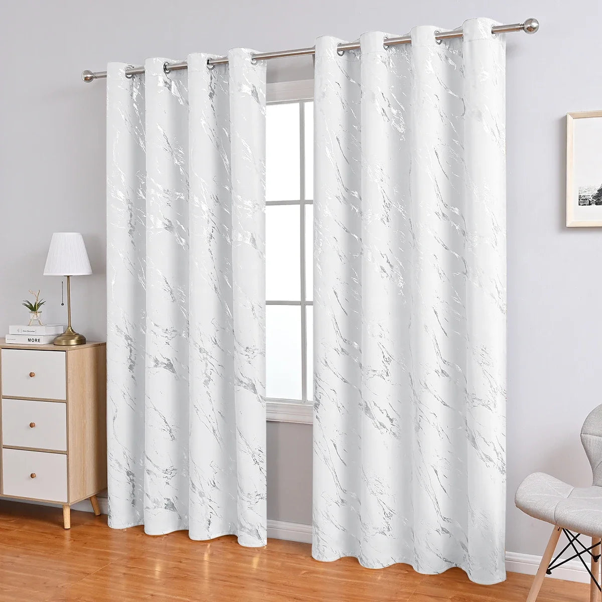 White curtain fabric with gray marble print hanging from a rod
