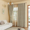 Light beige blackout printed curtains with floral patterns hanging in a room.