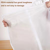 A hand holds a transparent zippered storage bag made of PEVA material.