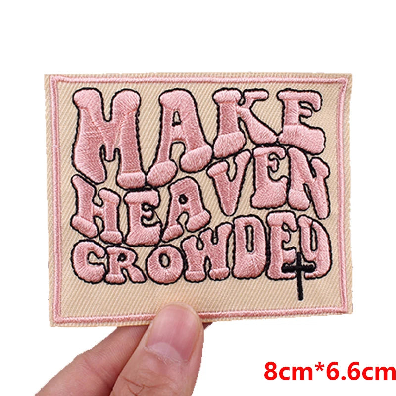 Pink embroidered patch with the text MAKE HEAVEN CROWDED in a distressed font