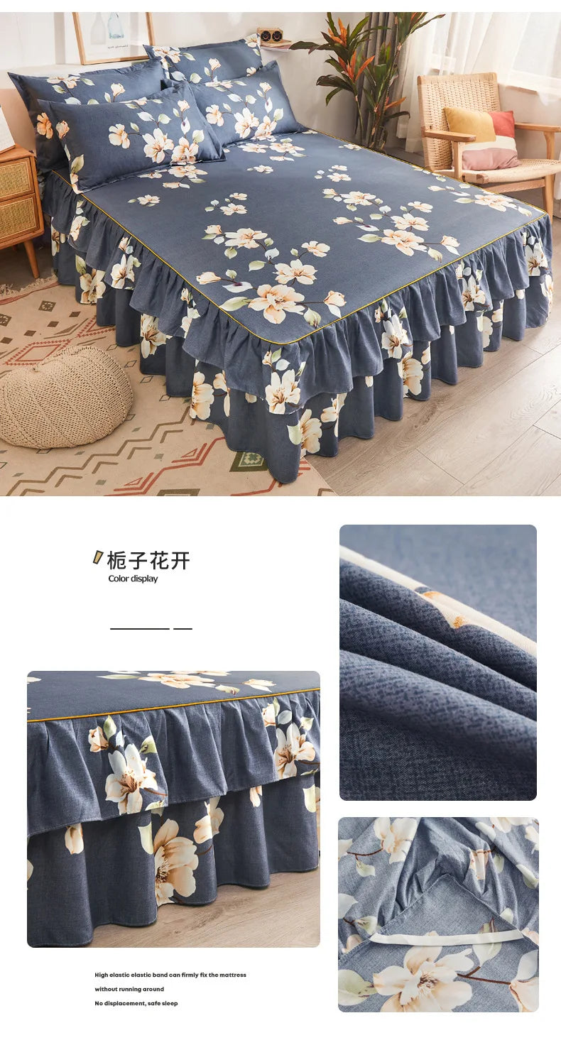 A navy blue printed bed skirt featuring white and yellow floral patterns on a bed.
