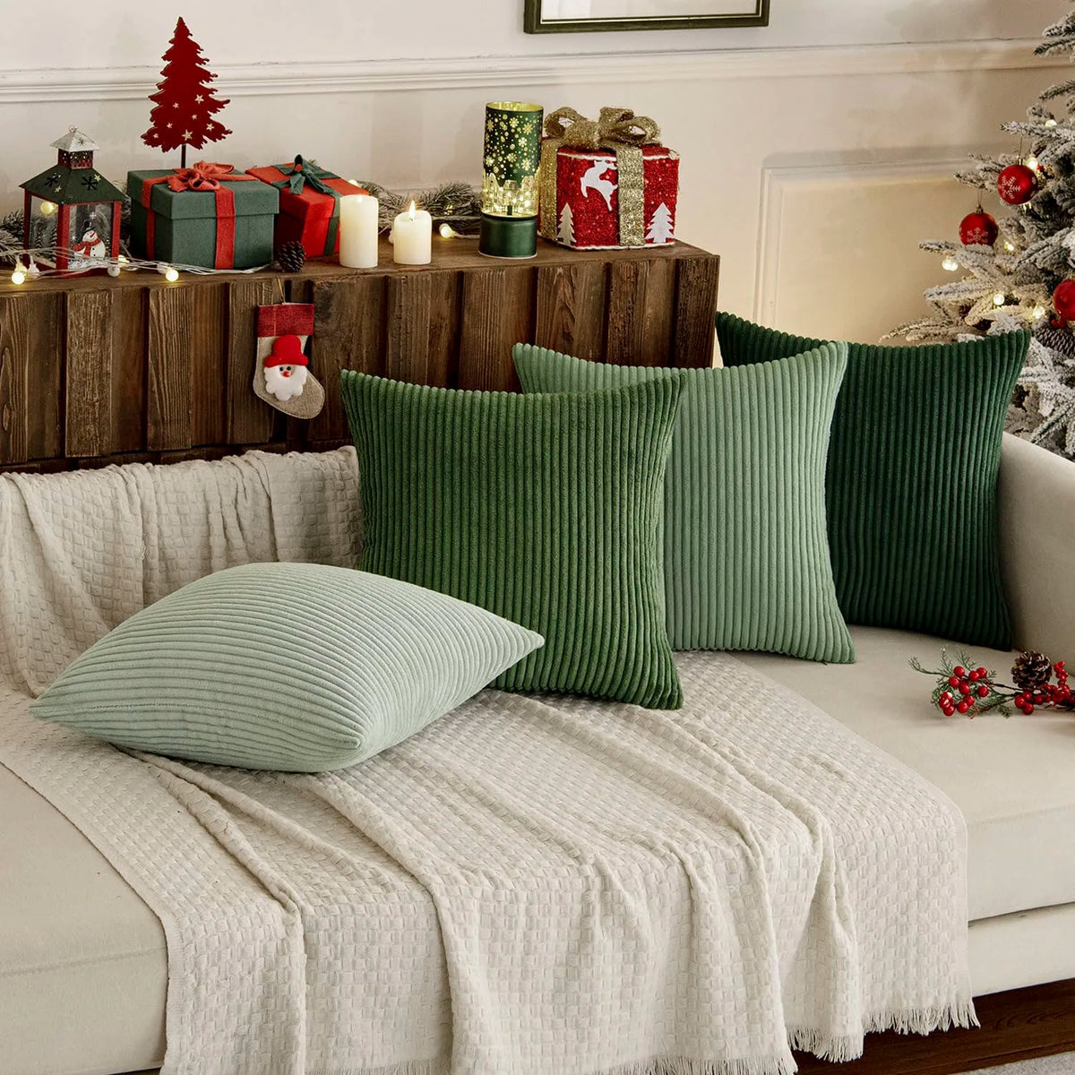 A set of four textured green throw pillow covers displayed on a light-colored sofa with rustic decor.