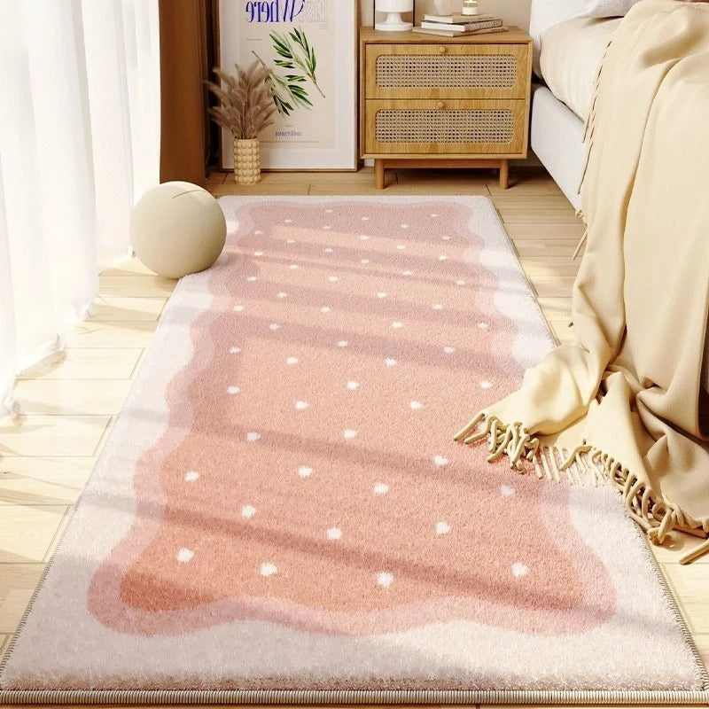 A rectangular pink and beige seasonal decor rug placed on a light wooden floor next to a sofa.