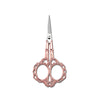 A pair of pink rose gold crafting scissors with a silver blade and ornate handles.