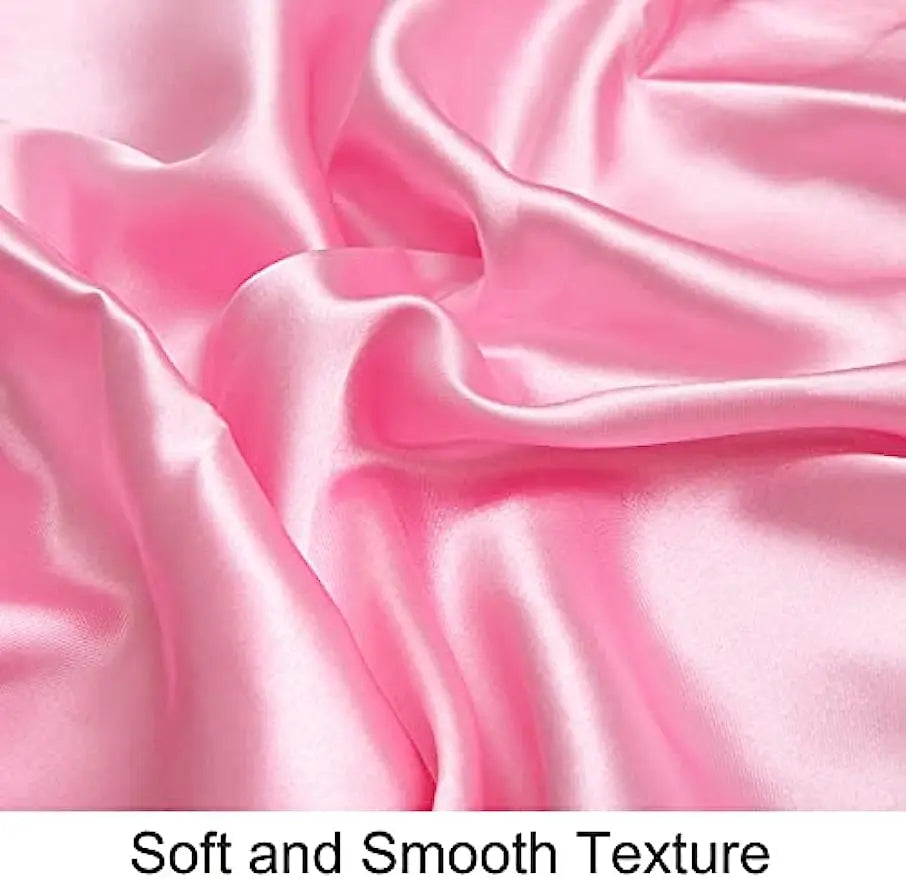 Close-up of a pink silky satin fabric showing soft folds and smooth texture.