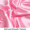 A close-up of pink silky satin fabric showing a soft and smooth texture.