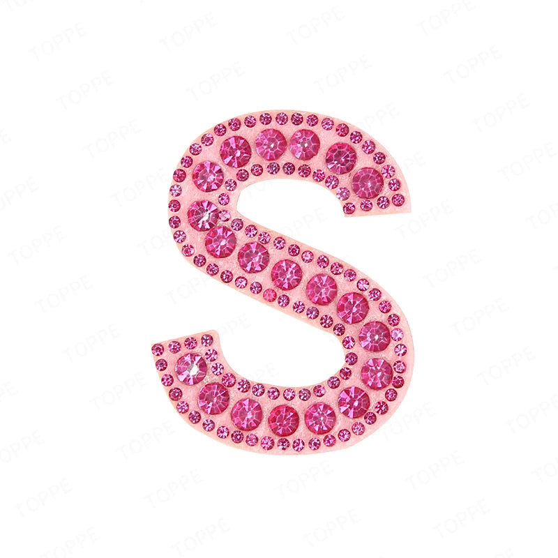 Pink rhinestone letter S patch with a glittery texture for DIY projects