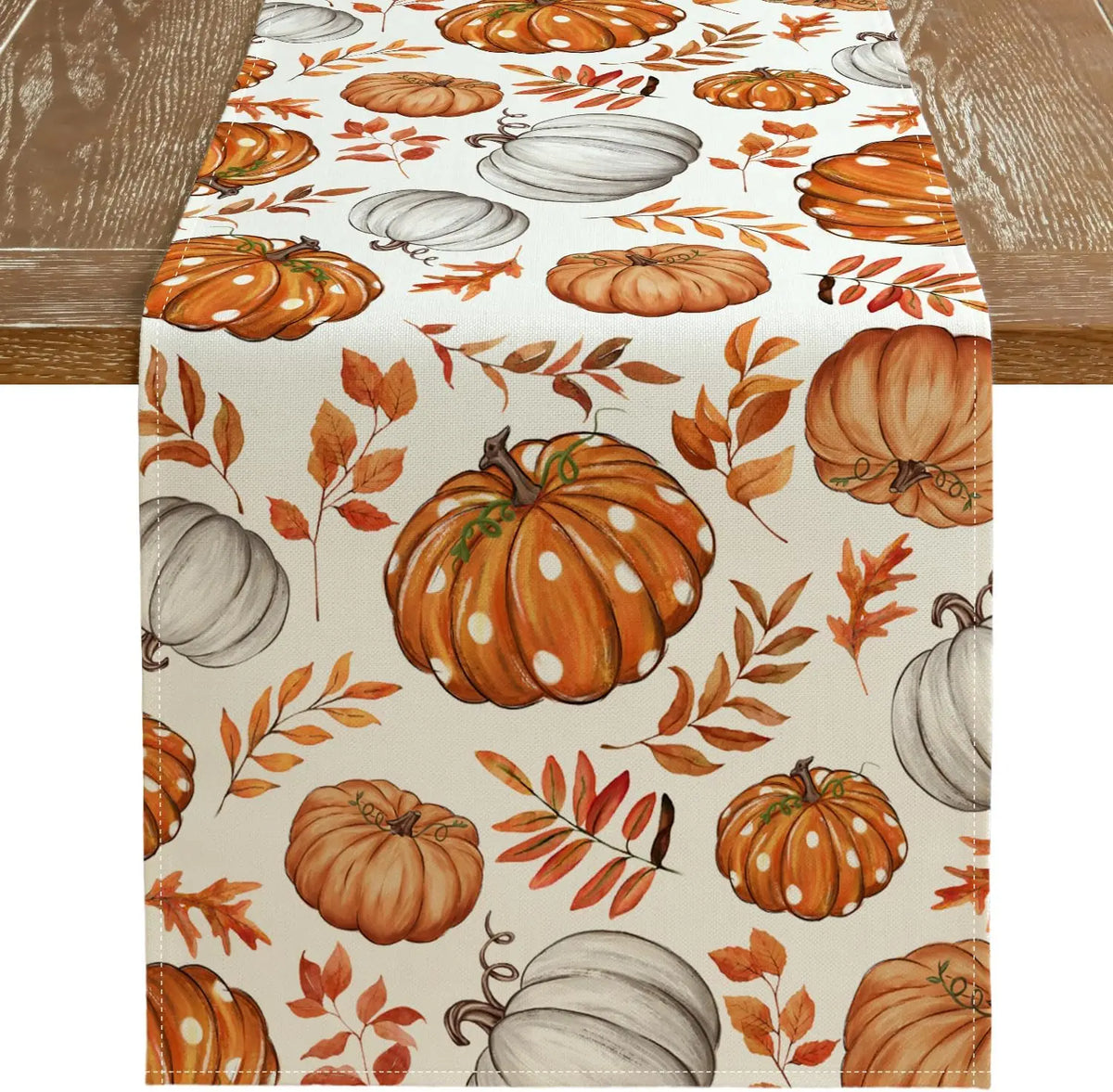 Linen table runner featuring an orange and white pumpkin pattern for autumn decor