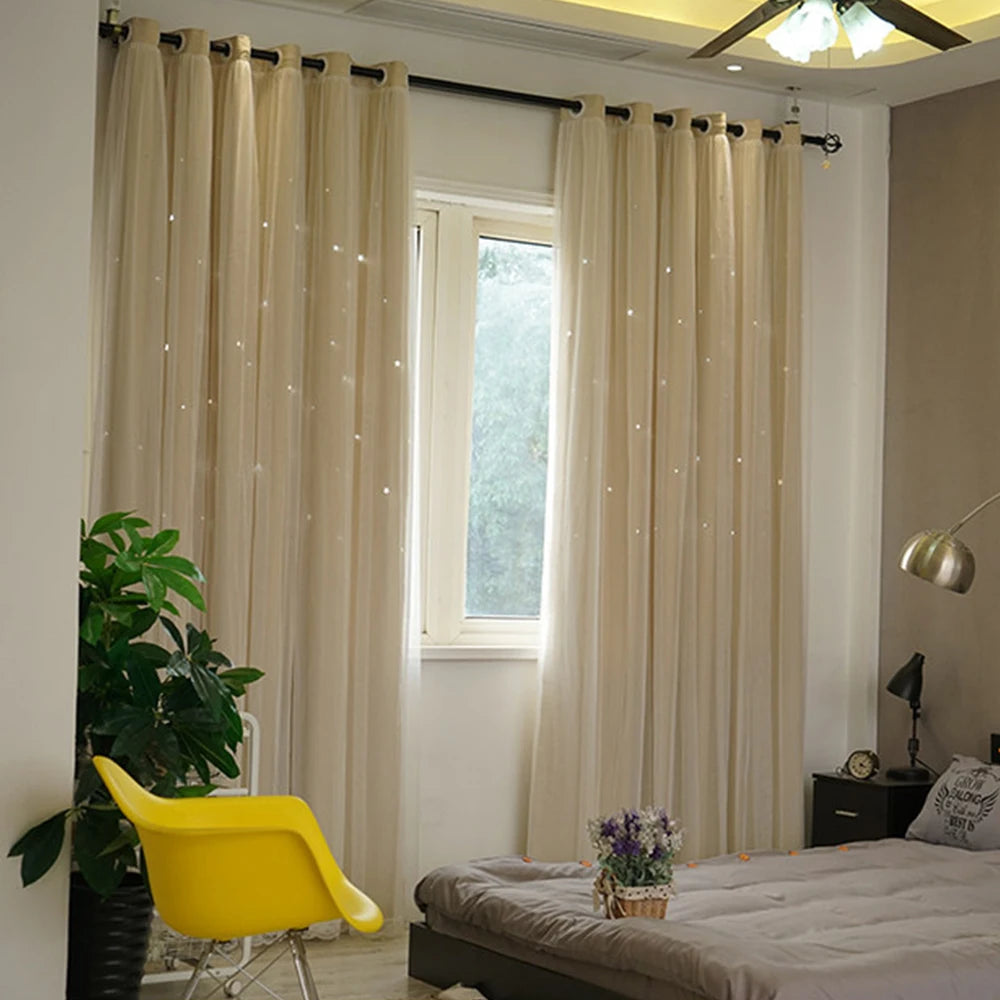 Light beige double-layer blackout curtains with a star pattern and sheer lace overlay framing a window.