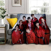 A group of seven male Kpop idols in red and black outfits posing for a 3D printed fleece throw blanket.