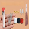 A hand shows a precision hand sewing kit including a glass tube, steel needles, and spools of thread.