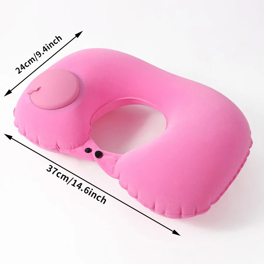 A pink inflatable neck pillow with a cutout and black fastening visible on a white background.