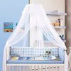 White sheer mosquito net canopy draped over a baby cot with blue and white patterned bedding