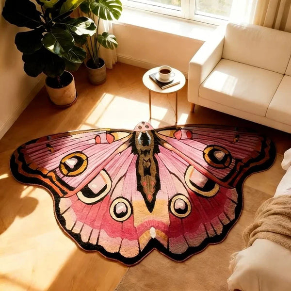 A pink and black irregular shaped plush floor rug is displayed on a wooden floor next to a window.
