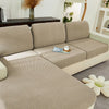 A beige jacquard knit sofa cushion cover featuring a geometric pattern on a sectional sofa.