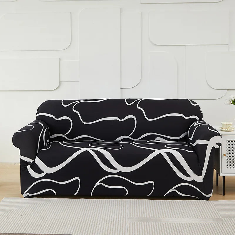 A black sofa covered in a white, wavy abstract pattern sits on a light-colored rug.