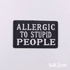 Black embroidered patch with white text that reads Allergic to Stupid People