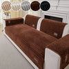 A brown ribbed sofa cushion with white trim and decorative fabric swatches shown on a white mantelpiece.