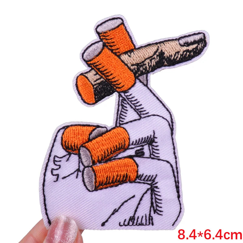 Embroidered skull iron-on patch featuring orange and gray elements on a white background