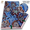 Cotton Satin Grand Wax fabric featuring intricate floral and leaf patterns in blue, purple, and brown tones