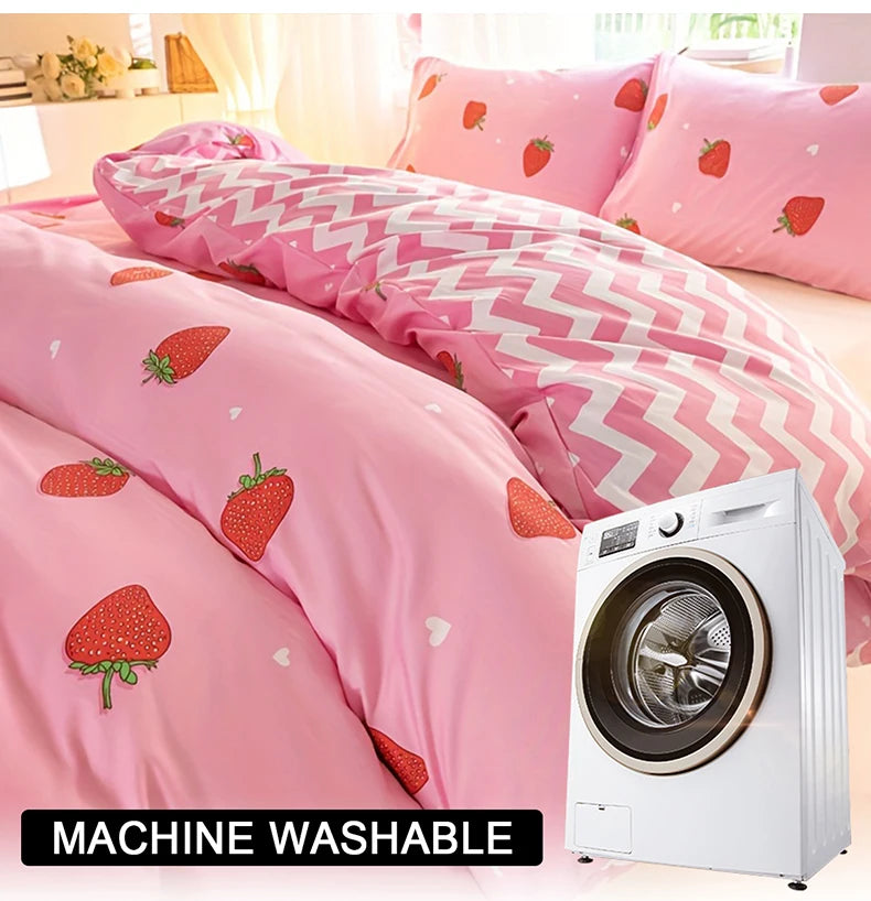 Pink strawberry print duvet cover set displayed on a bed next to a white washing machine.