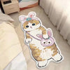 A cute cartoon cat plush carpet with pink ears and a bow is shown on a light wooden floor.