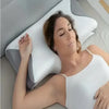 A woman is lying down and resting her head on a white memory foam contour pillow for neck pain relief.
