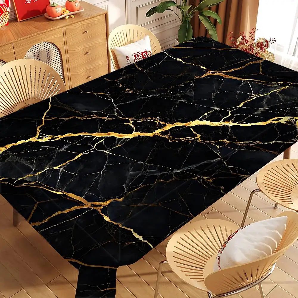 A black marble table cloth with gold veining displayed on a wooden table.