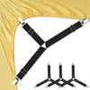A set of black adjustable triangle bed sheet clips with silver hardware shown against a yellow fabric background.