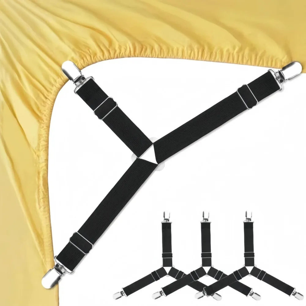 A set of black adjustable triangle bed sheet clips with silver hardware shown against a yellow fabric background.