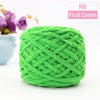 A ball of bright green chunky velvet knitting yarn labeled N8 Fruit Green.