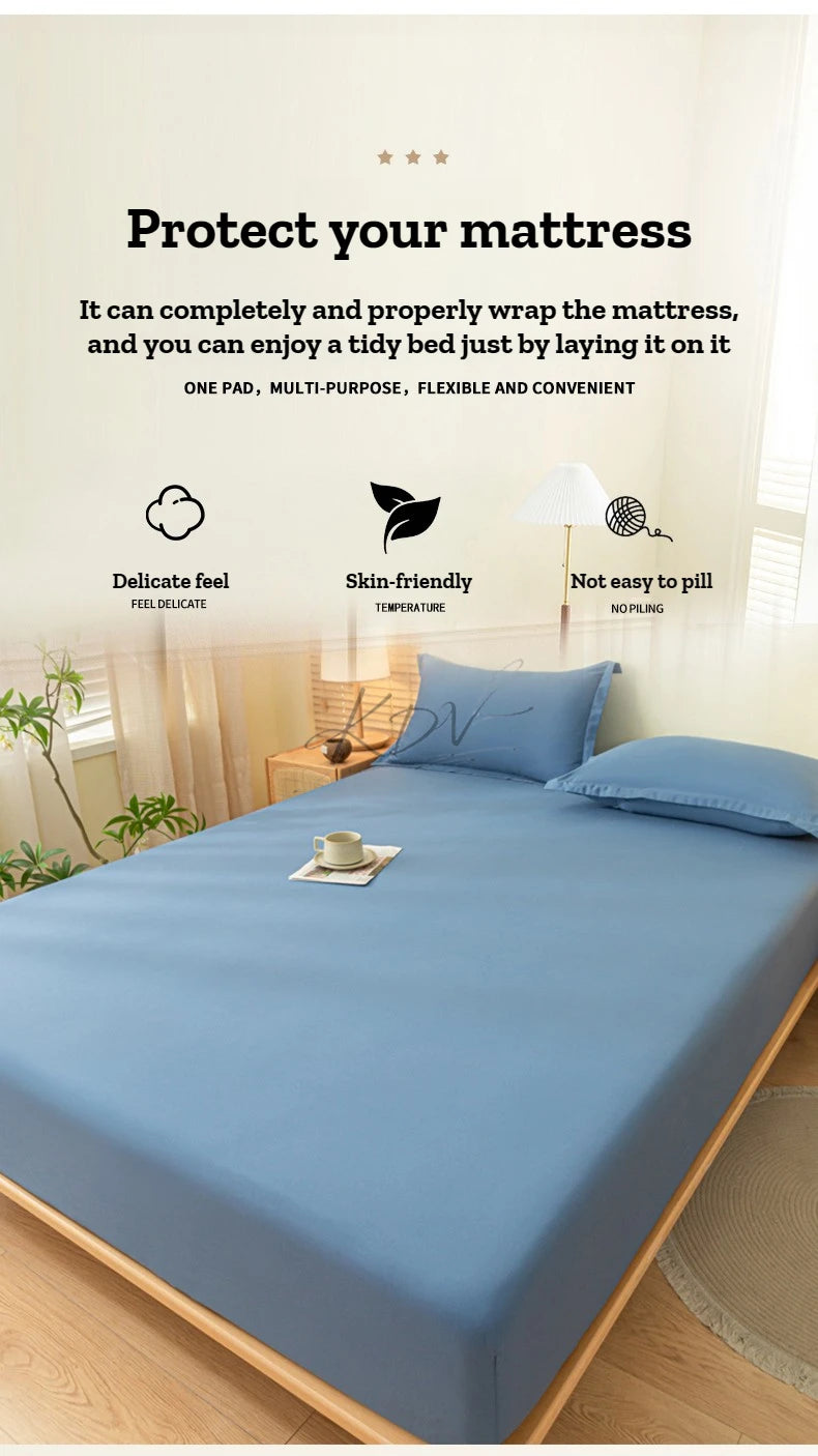 A blue fitted sheet set and pillowcase is shown protecting a mattress with a protective pad.