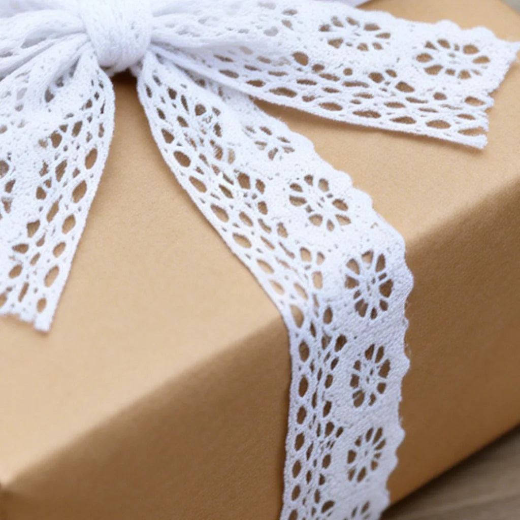 A gift box tied with a white cotton embroidered lace trim ribbon.