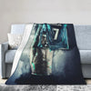 A dark, moody illustration of a muscular man with a seven on his chest, featured on a wool throw blanket.