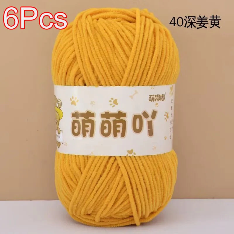 A ball of bright yellow chenille yarn labeled with Chinese characters for crochet and knitting projects.