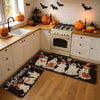 A black and white Halloween ghost pumpkin print non-slip kitchen rug set placed on a wooden floor.