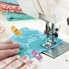 Hands are placing colorful multipurpose sewing and craft clips onto a blue fabric under a sewing machine.