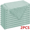 A stack of light mint green decorative cloth napkins.