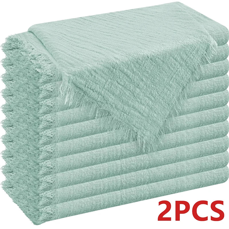A stack of light mint green decorative cloth napkins.