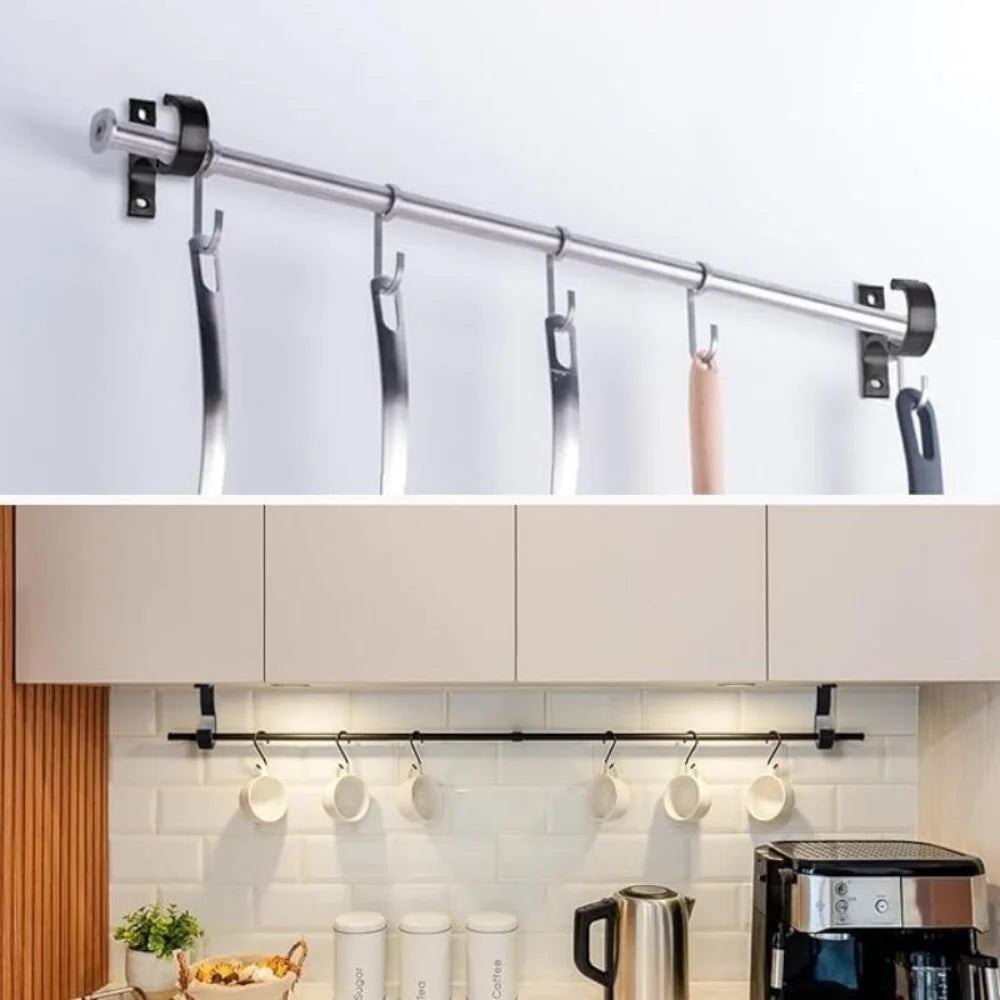 A silver curtain rod with multiple hooks is mounted on a white wall above kitchen cabinets.