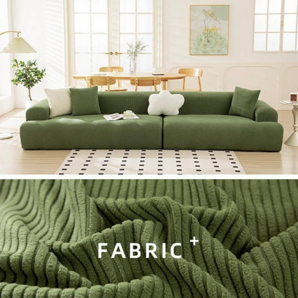 A textured olive green fabric sofa slipcover is shown in a bright, airy living room setting.