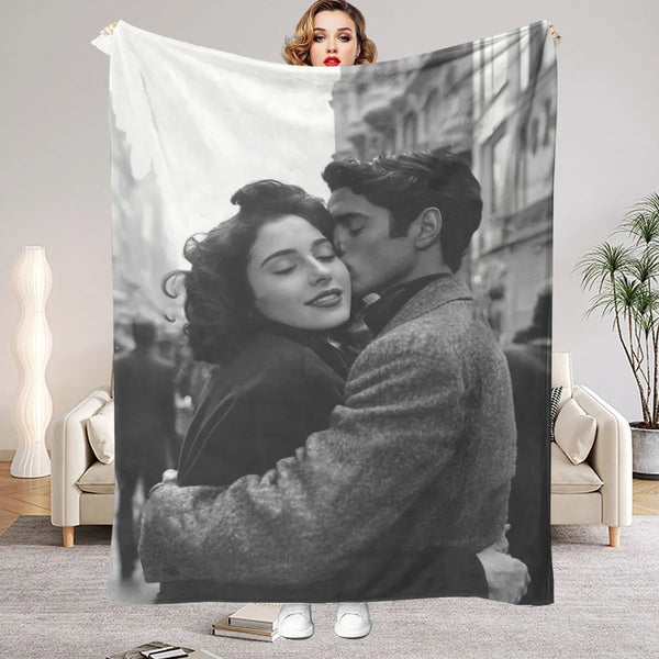 A personalized photo blanket featuring a black and white portrait of a man and woman embracing.