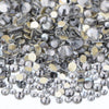 A close-up view of a mix of clear and gold glass rhinestones for DIY crafts.