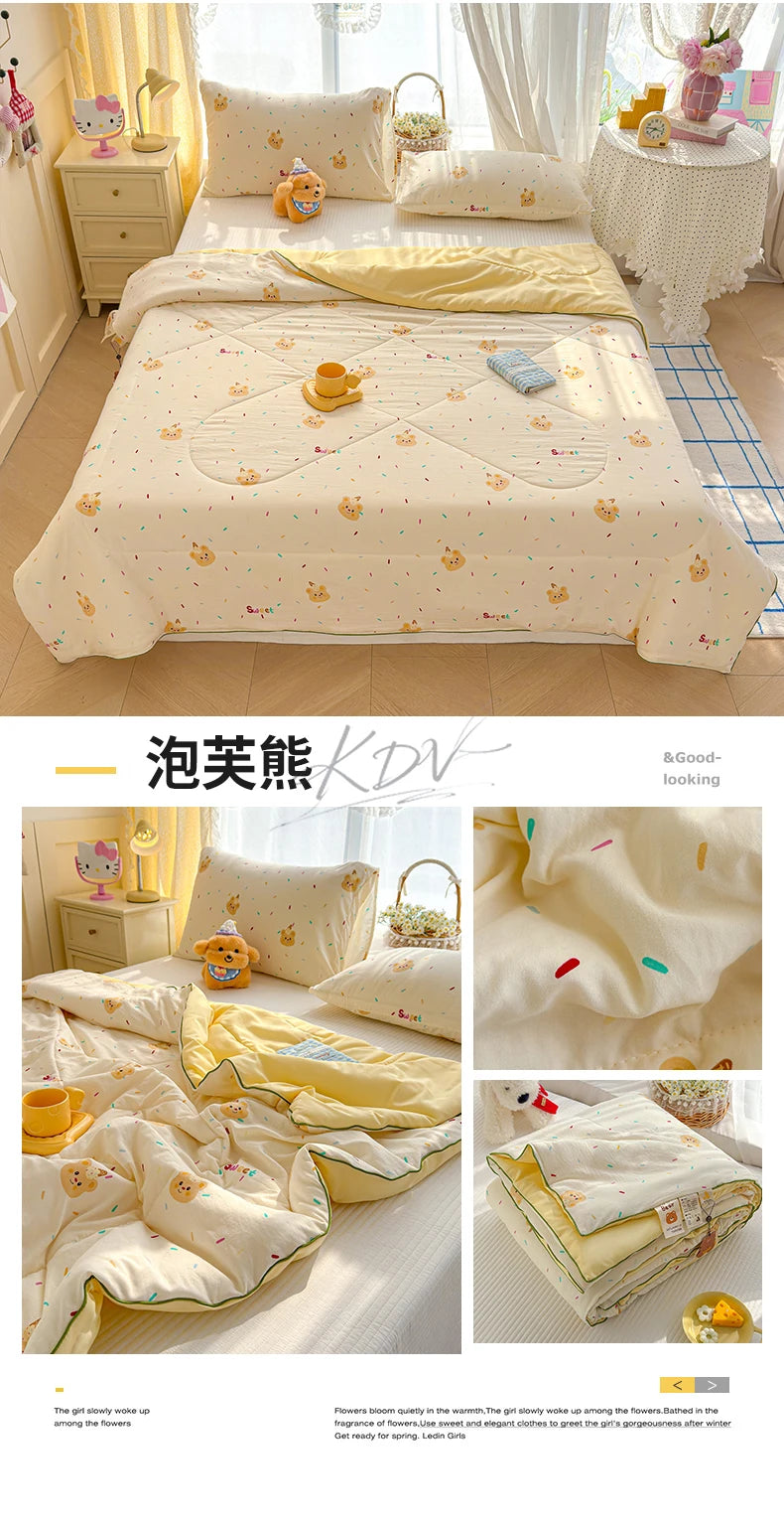 A yellow cartoon pattern lightweight summer quilt displayed on a bed with white bedding and accessories.
