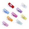A collection of colorful plastic sewing clips in red, blue, purple, and yellow for crafting projects.