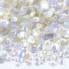A close-up view of a mix of clear and gold glass rhinestones for DIY crafts.