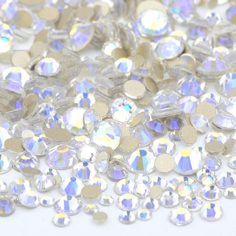 A close-up view of a mix of clear and gold glass rhinestones for DIY crafts.